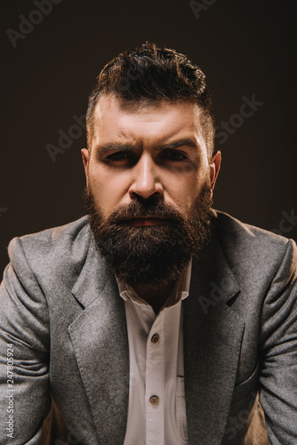 handsome beard businessman in formal wear isolated on brown