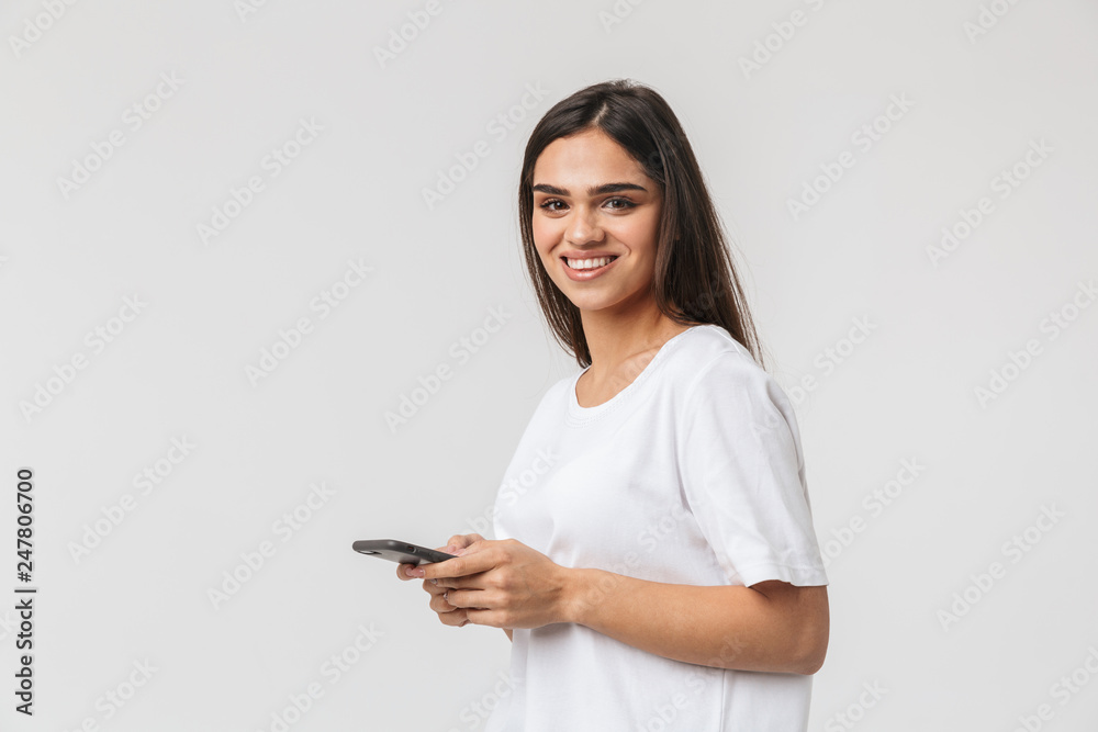 Smiling young woman casualy dressed standing Smiling young woman casualy dressed standing