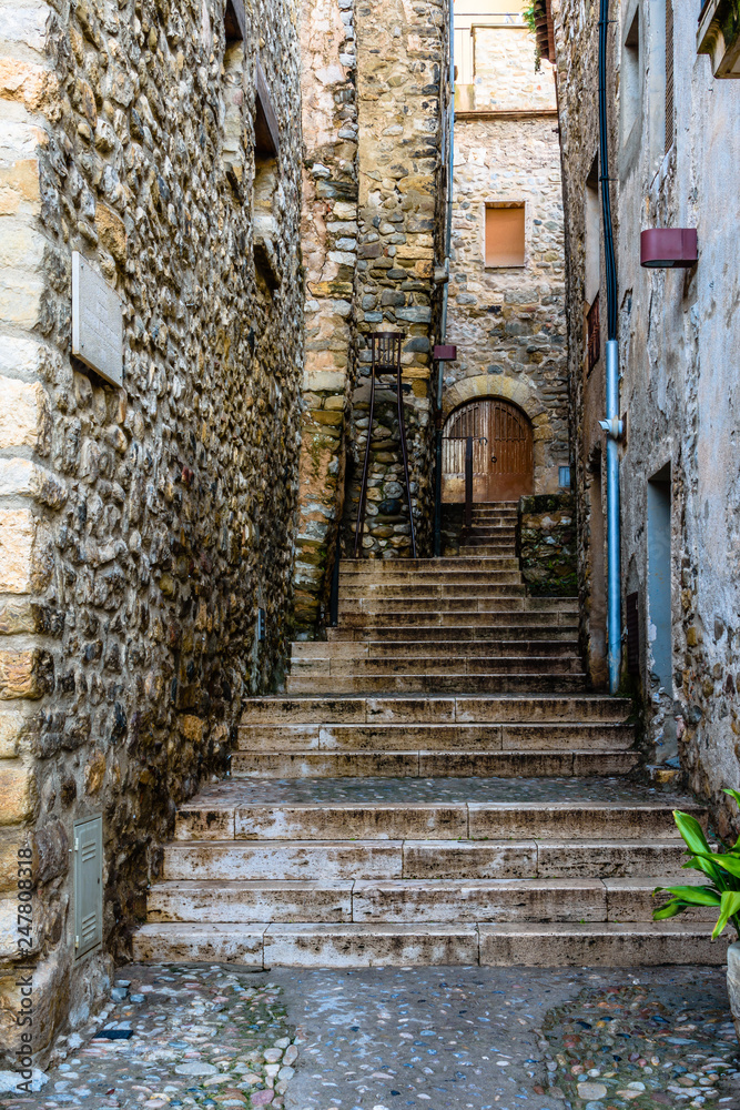 Narrow street in medieval village of Besalu (Catalonia, Spain).