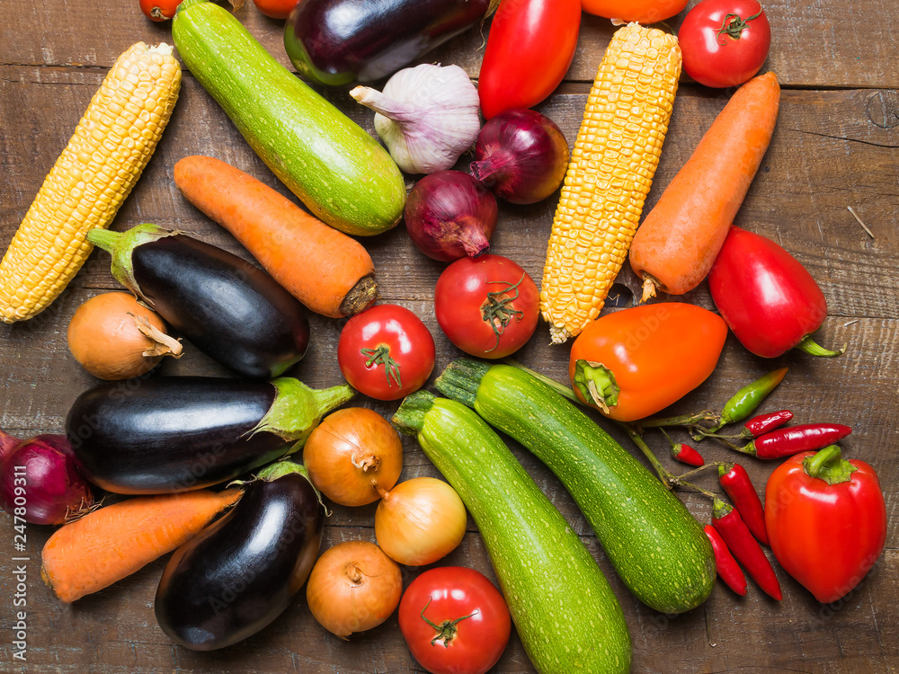 Layout with different vegetables on old wooden table. Layout with different vegetables on old wooden table.