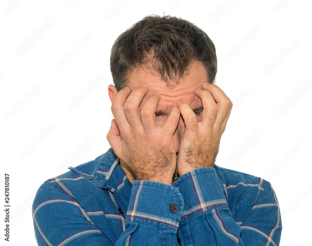 Portrait of despair young man closed face by two hands. Isolated on a white background. Portrait of despair young man closed face by two hands. Isolated on a white background.