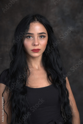 Young beautiful girl on a dark background