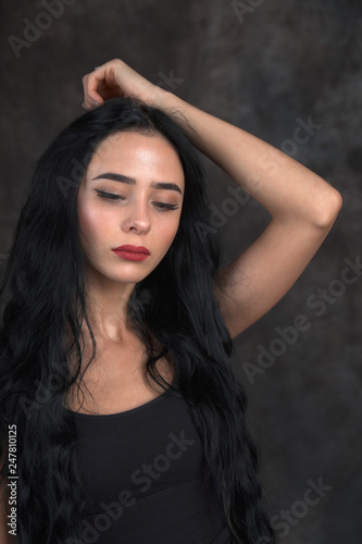 Young beautiful girl on a dark background © Valiantsina