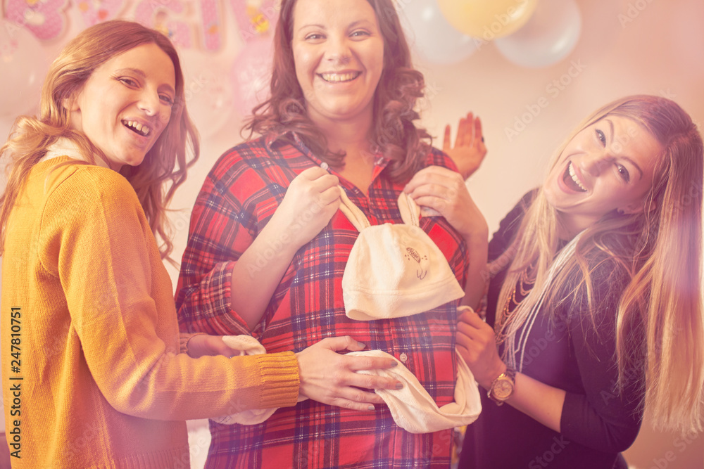 Pregnant woman celebrating baby shower party with friends. Pregnant woman celebrating baby shower party with friends.