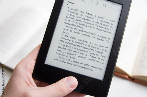 Hand holding ebook with text about future