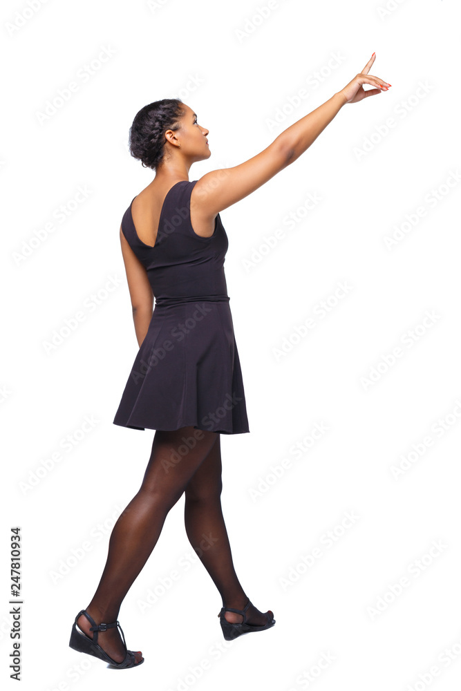 Back view of walking young black girl. Back view of walking young black girl.