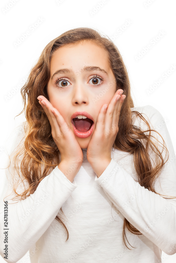 Surprised and horrified young girl looking at camera with eyes wide-opened isolated on white background Surprised and horrified young girl looking at camera with eyes wide-opened isolated on white background