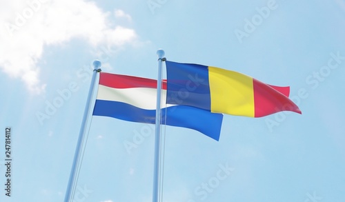 Romania and Netherlands, two flags waving against blue sky. 3d image