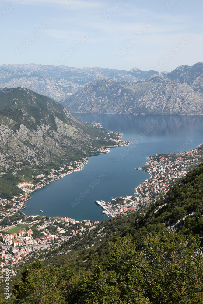 Panorama UNESCO World Heritage Site bay of Kotor with high mountains plunge into adriatic sea and Historic town of Kotor, Montenegro