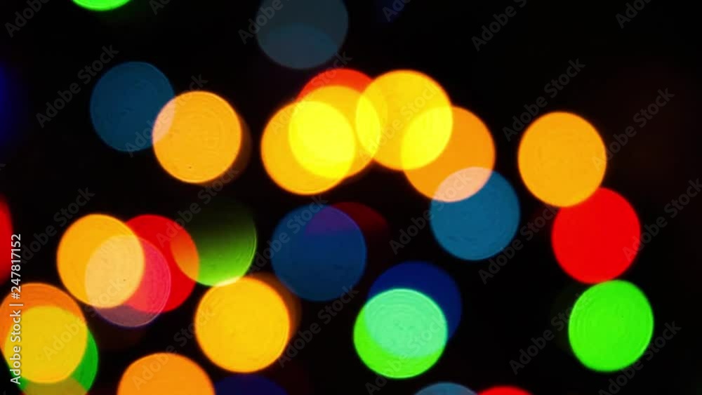 Lights garlands on black, abstract background with bokeh effect. Christmas tree lights twinkling. Winter Holidays footage. Lights garlands on black, abstract background with bokeh effect. Christmas tree lights twinkling. Winter Holidays footage.