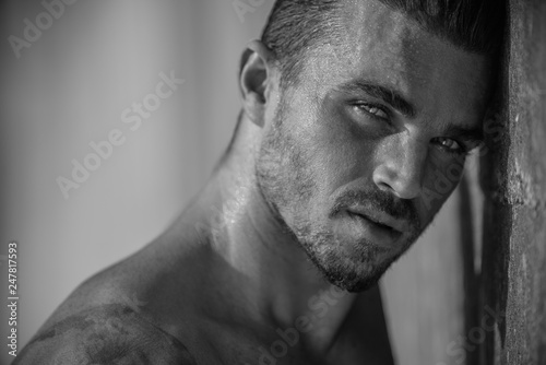 Portrait of a handsome caucasian male model posing on the beach