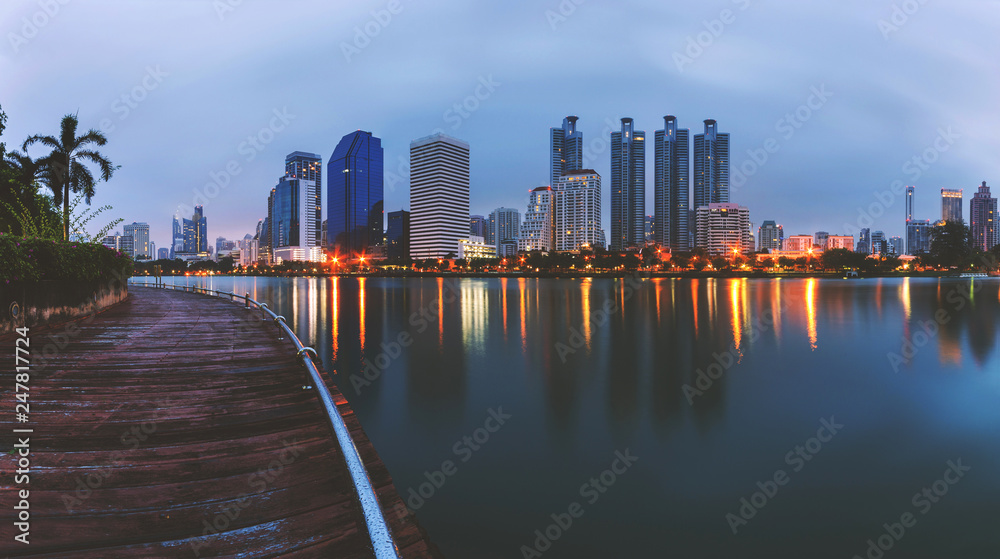night modern cityscape panoramic skyscraper images with lights urban dusk in twilight of landscape the landmark midtown in Thailand property waterfront building reflection at morning.