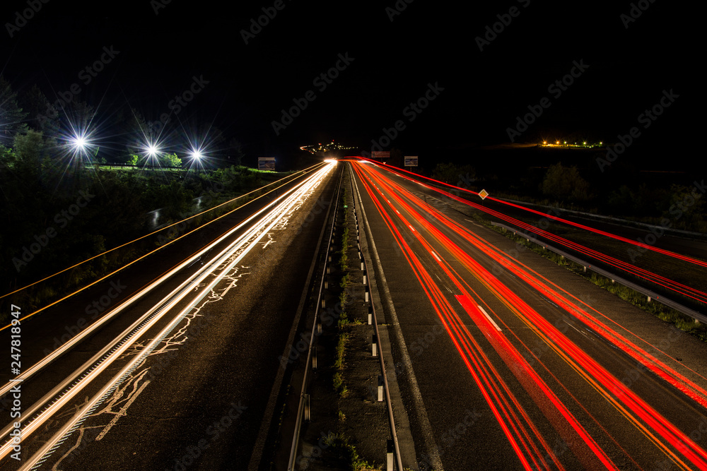 Headlights of cars, taken on highway with long-term exposure to the background of the sky