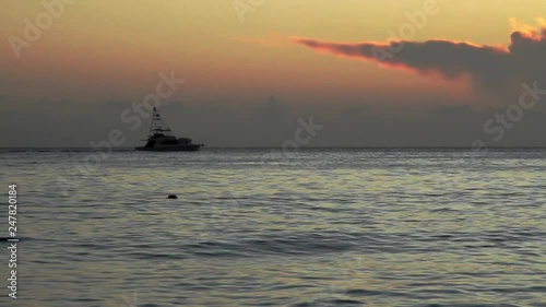 Yatch silhouette in caribbean red sunset photo