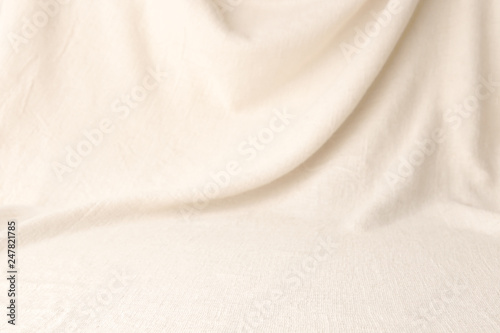 Abstract drapery cloth background. Beige woven textile drape with empty place.