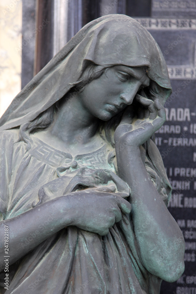 Detail of an old marble tombstone at the central cemetery in Zagreb, Croatia