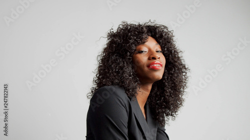 portrait of black woman in studio wear office black tie and red lipstick