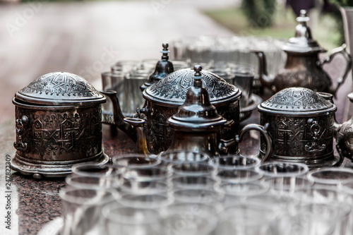Fototapeta Naklejka Na Ścianę i Meble -  Silver tea set with glasses and tea pots in Marrakesh Morocco