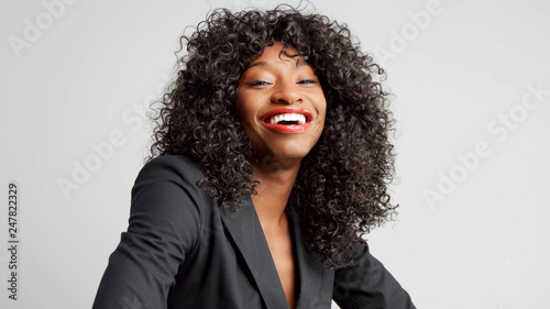 happy laughing businesswoman in studio shoot on light grey