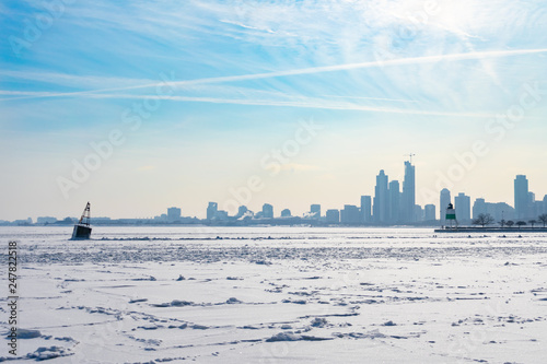 A Buoy in a Frozen Lake Michigan in Chicago with the skyline after a Polar Vortex