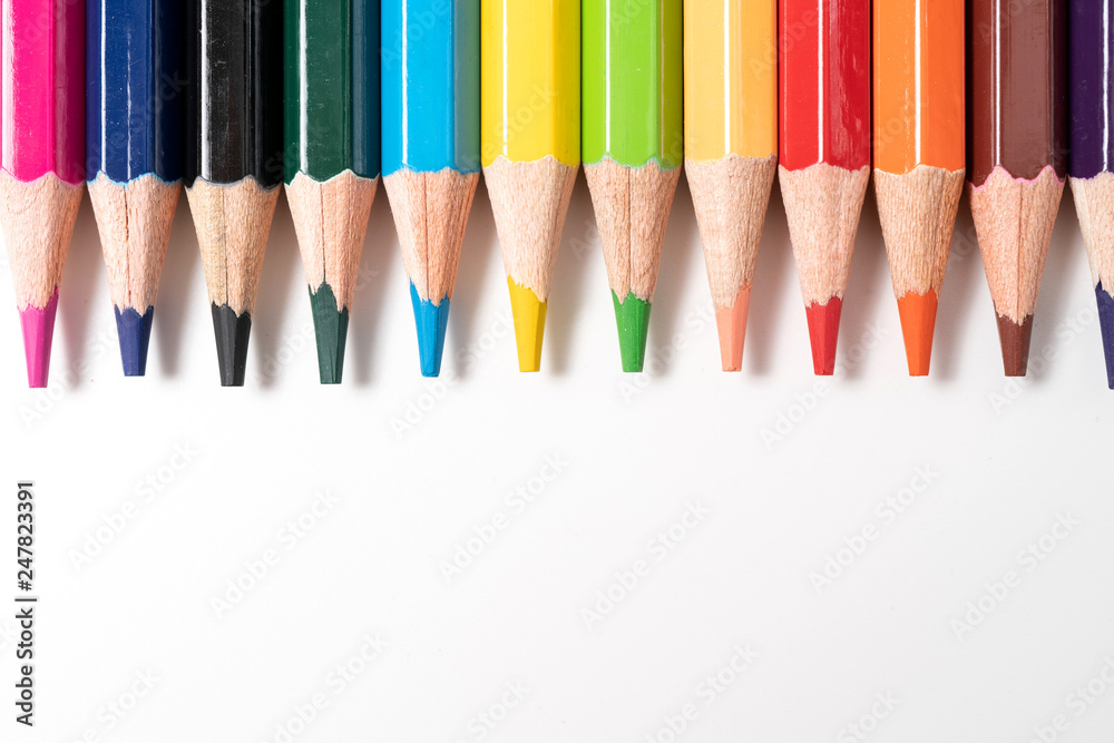 Colored pencils in a row isolated on white background. Colored pencils in a row isolated on white background.