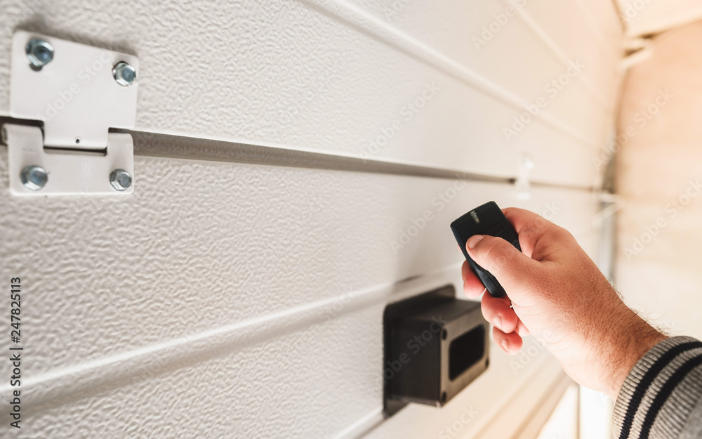 Garage door PVC. Hand use remote controller for closing and opening garage door Garage door PVC. Hand use remote controller for closing and opening garage door
