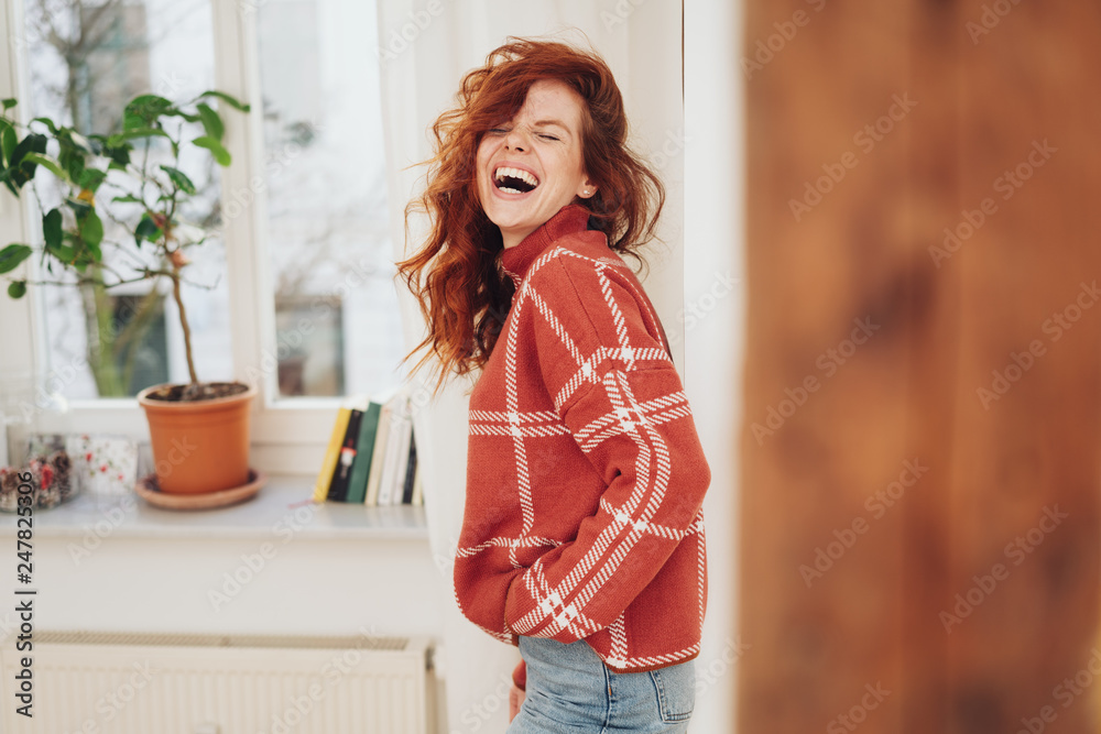 Exuberant young woman laughing out loud
