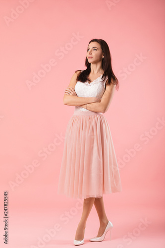 beautiful charming woman looking at camera on pink background. women's day. Mother's day