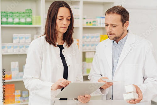 Concerned pharmacists checking medicines