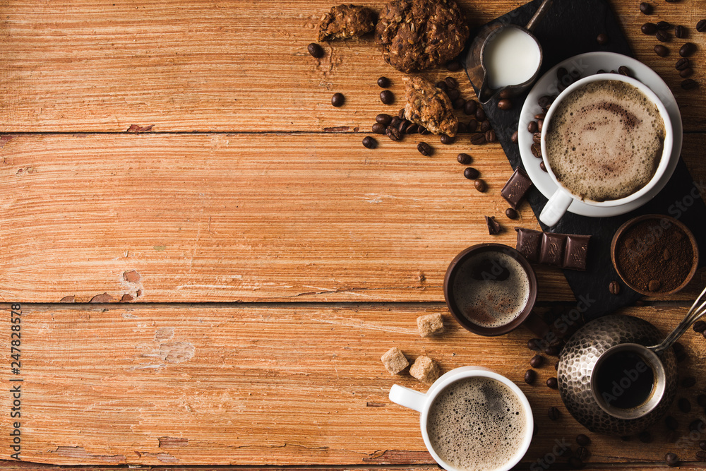 Black coffee with milk flatlay view on wooden background