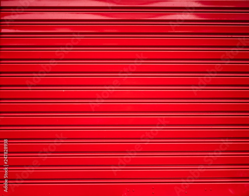 Background and texture of red color corrugated metal sheet,Slide door ,Roller shutter texture with shadow and hilight effect.