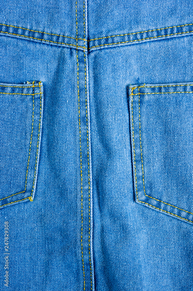 Blue washed faded jeans texture with seams Blue washed faded jeans texture with seams