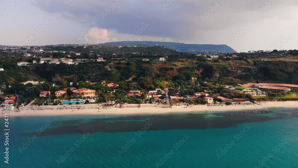 Dark cloud over blue sea and shoreline with hotel and resort buildings. Aerial shot Dark cloud over blue sea and shoreline with hotel and resort buildings. Aerial shot
