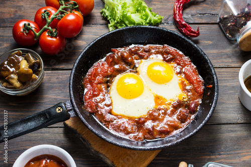 Shakshuka, Fried Eggs in Tomato Sauce in iron frying pan. Israel food.