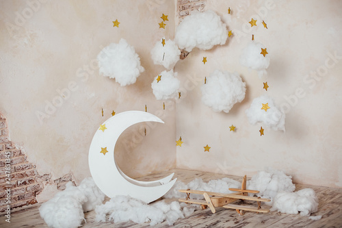 Children's location for a photo shoot. Moon with stars, clouds and airplane. Dreamy decor. Elements of the interior.