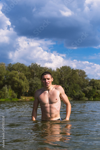 Portrait of a handsome young man in the water.