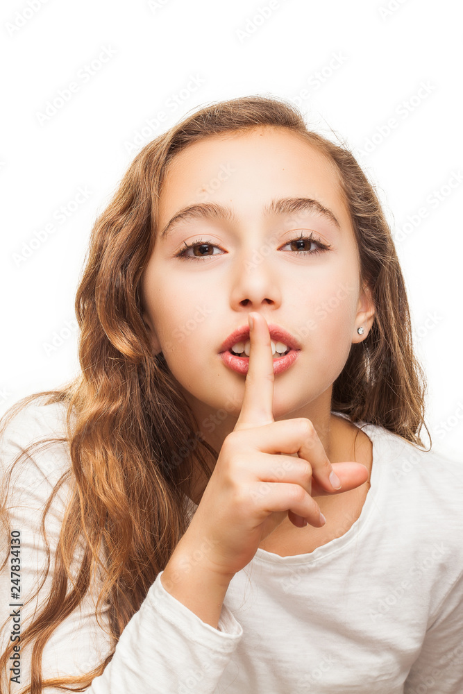 Young girl with holding finger on her lips on silence gesture isolated on white background