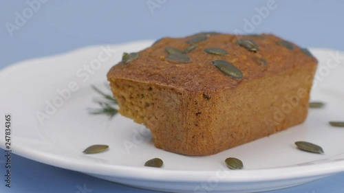 Gluten-Free pumpkin bread with pumpkin seed in white plate set on light blue background. photo