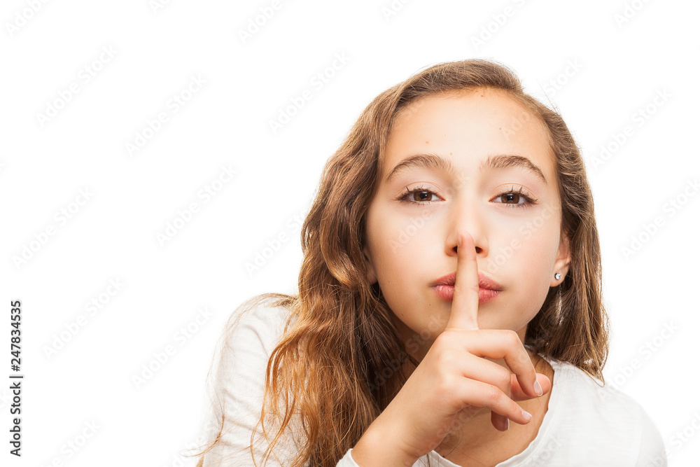 Young girl with holding finger on her lips on silence gesture isolated on white background Young girl with holding finger on her lips on silence gesture isolated on white background