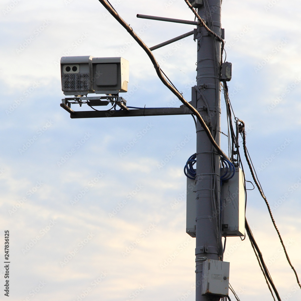 Street speed camera on a pole in Moscow against the blue sky Street speed camera on a pole in Moscow against the blue sky