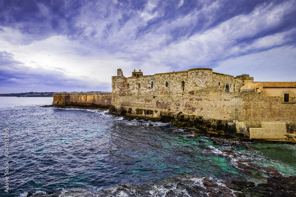 View of the castello maniace in Syracuse with dramatic sky, Sicily