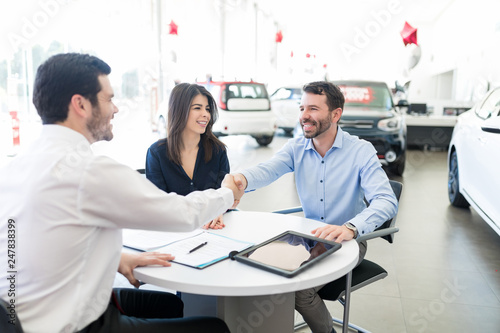 Cheerful Man Shaking Hands With Car Seller