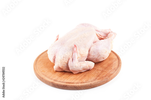 raw chicken carcass on wood desk