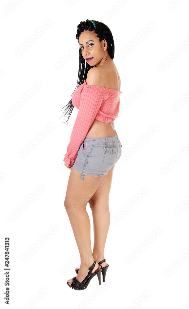 Woman standing in profile in jeans shorts Woman standing in profile in jeans shorts