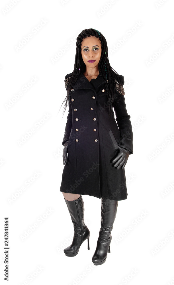 Young woman standing in black coat and boots Young woman standing in black coat and boots
