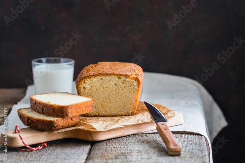 Tasty homemade traditional cake with a glass of milk on wooden baclground