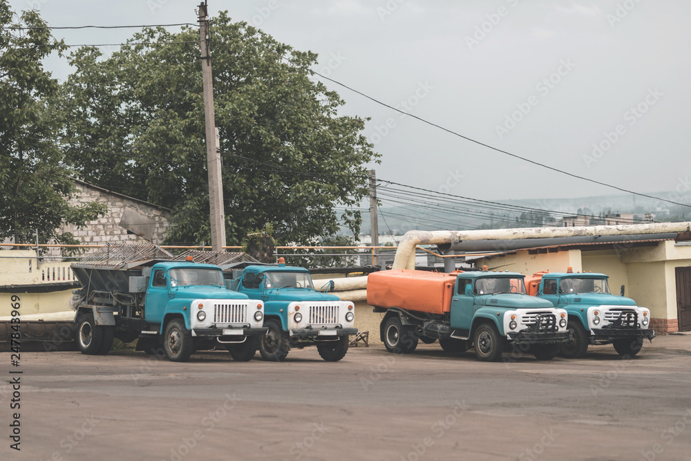 trash truck or dump-truck municipality sanitation salubrity truck fleet of city vehicles for urban garbage collector service with retro car transportation for sanitation services to city residents