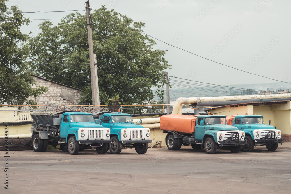 trash truck or dump-truck municipality sanitation salubrity truck fleet of city vehicles for urban garbage collector service with retro car transportation for sanitation services to city residents