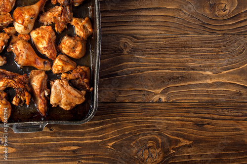 Baked chicken pieces on baking sheet