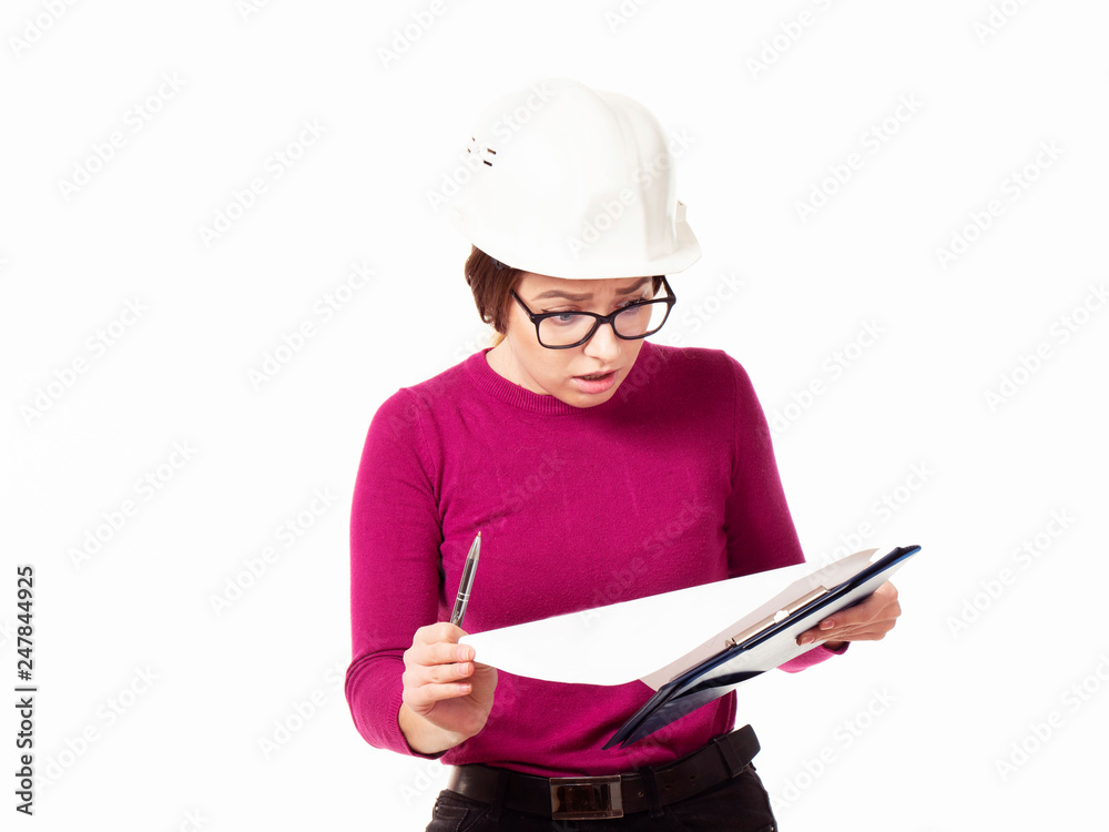 Emotional girl brigadier in a white helmet with glasses and a folder in his hands on a white background Emotional girl brigadier in a white helmet with glasses and a folder in his hands on a white background